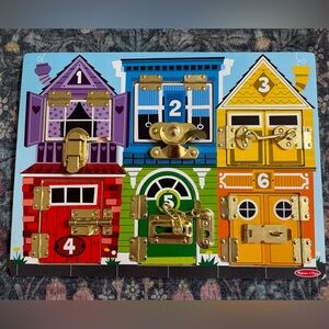 Melissa & Doug Colorful House Lockboard - Purple Blue Yellow Red Green Orange